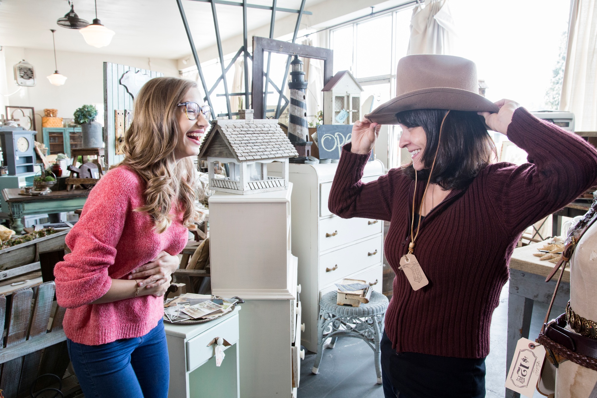 Two caucasian women shopping in an antique store