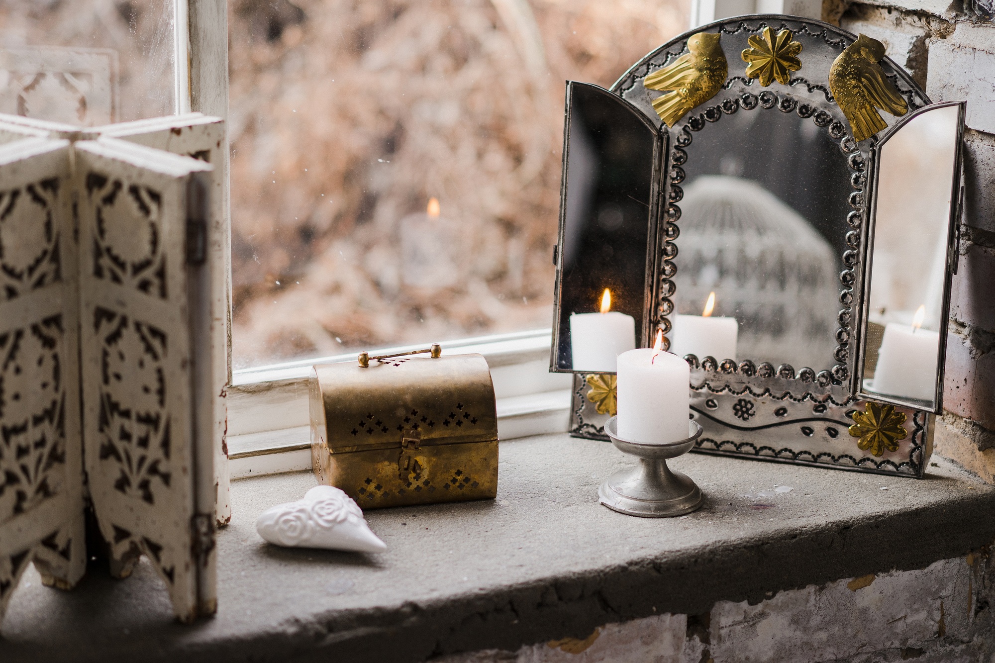 Vintage decorations on stone windowsill.